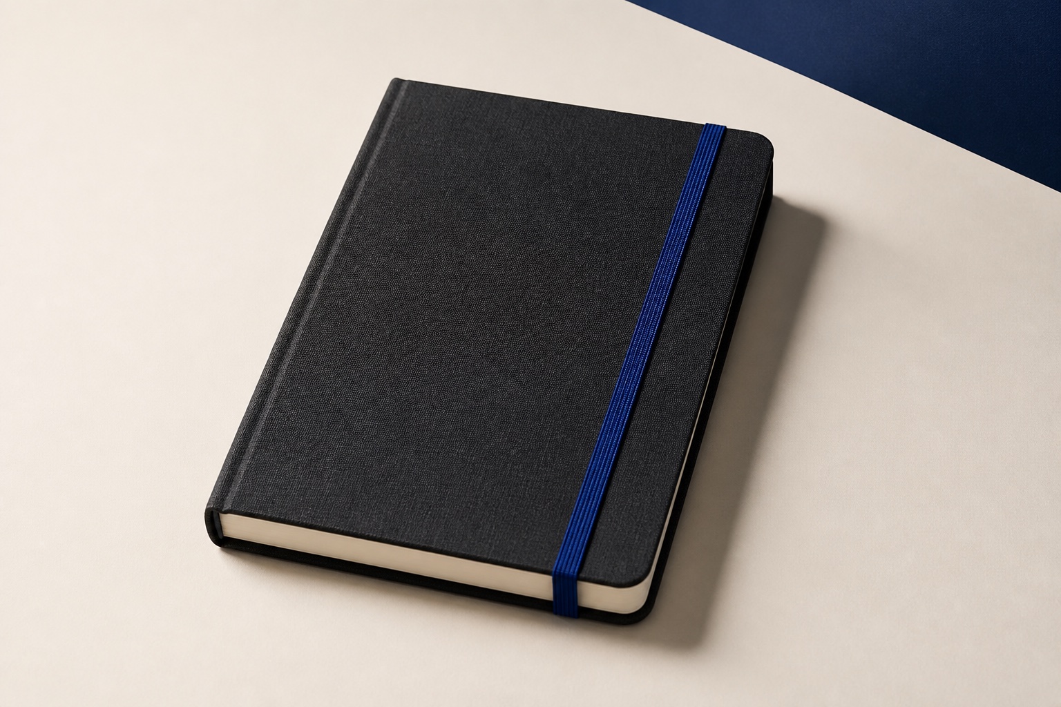 Unbranded charcoal fabric-bound notebook with a cobalt elastic band